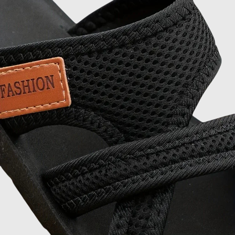 Lightweight flat sandal in black, also available in red and brown, with a simple clean design