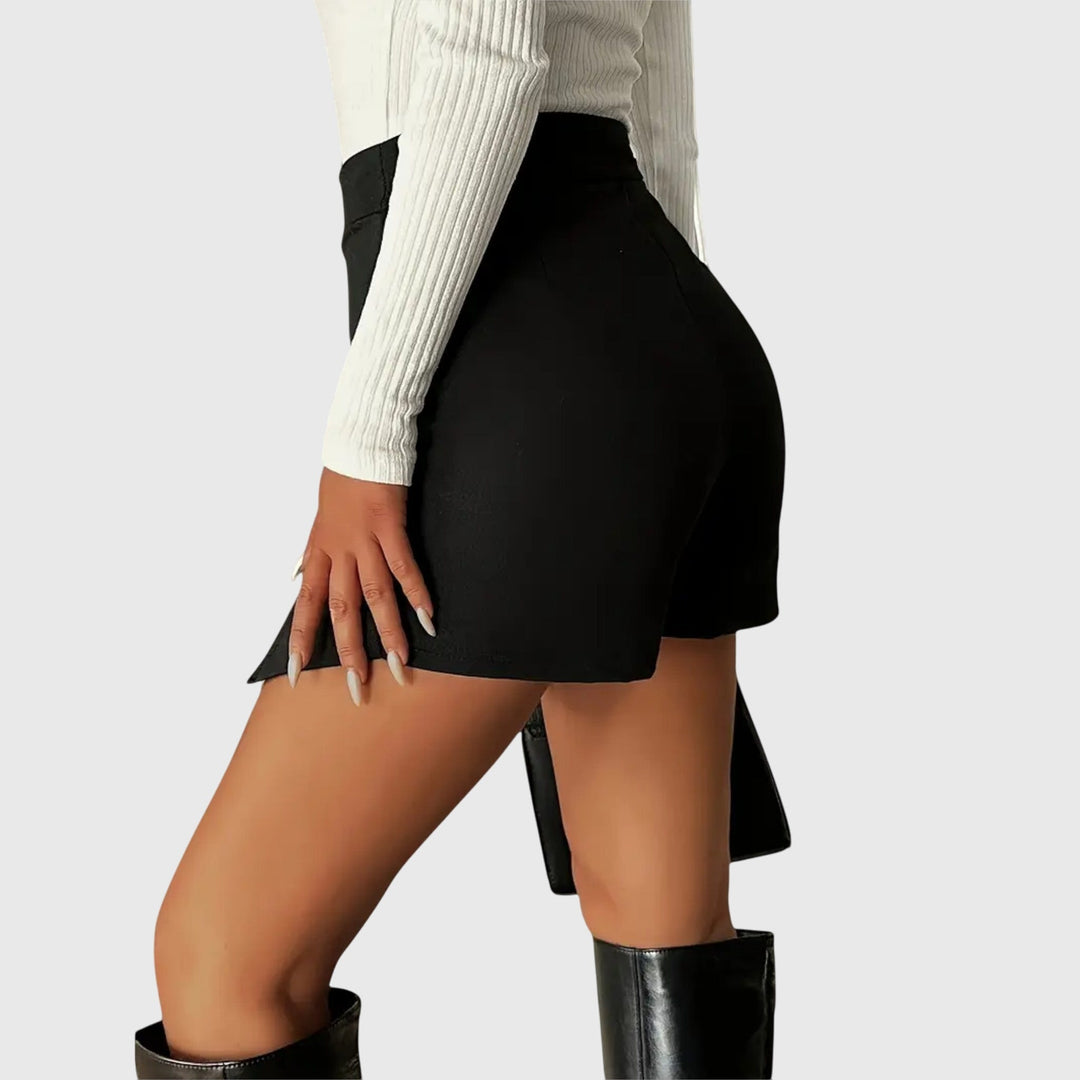 A woman wearing a sleek high-waisted black pencil skirt with a hem slit.