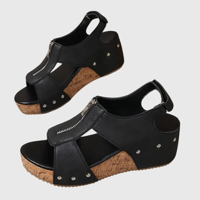 A woman standing at ease in wide-fit supportive comfort sandals with adjustable straps.