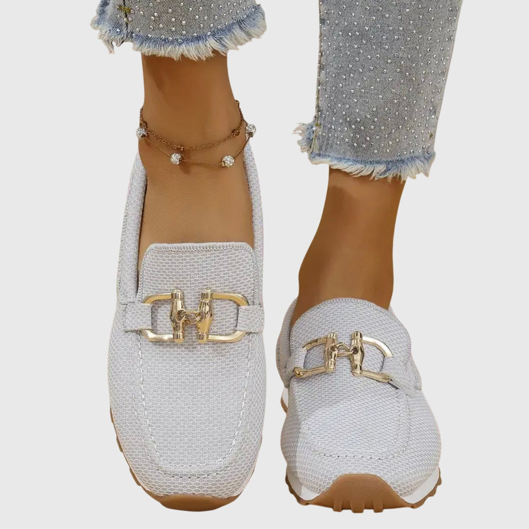 Women's beige comfort slip-on trainers with a cushioned sole and elegant metallic detail