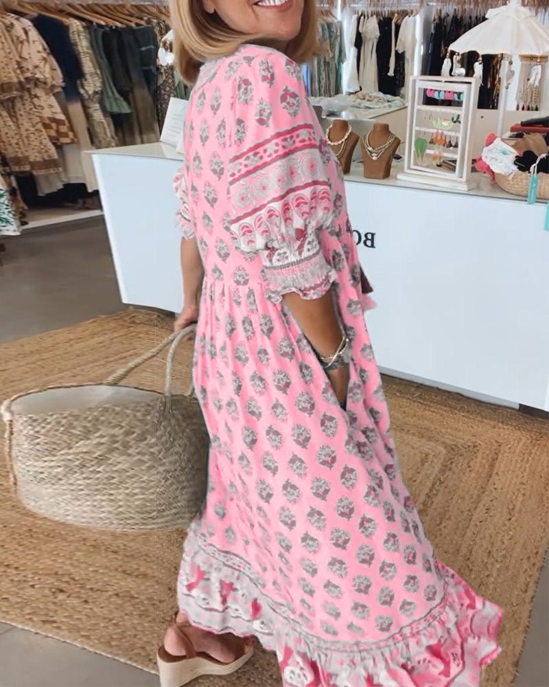A woman wearing the Patricia boho floral midi dress with a fringed neckline and ruffled skirt.