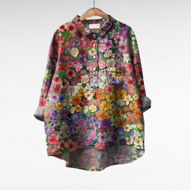 A woman wearing an elegant printed summer blouse with trousers, looking cool and stylish on a warm day.