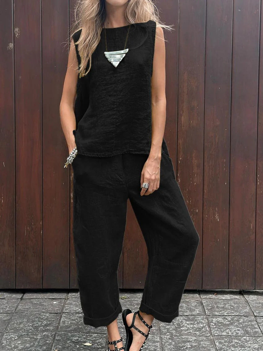 A woman wearing a relaxed sleeveless top with ankle-length trousers, easy and elegant.