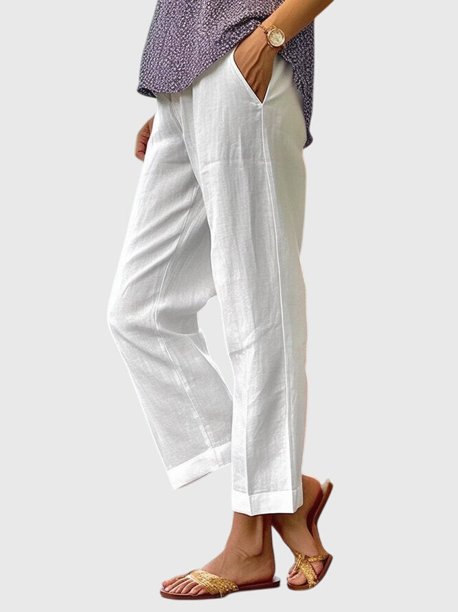 A woman wearing elegant tailored trousers with a flattering straight-leg cut and clean lines.