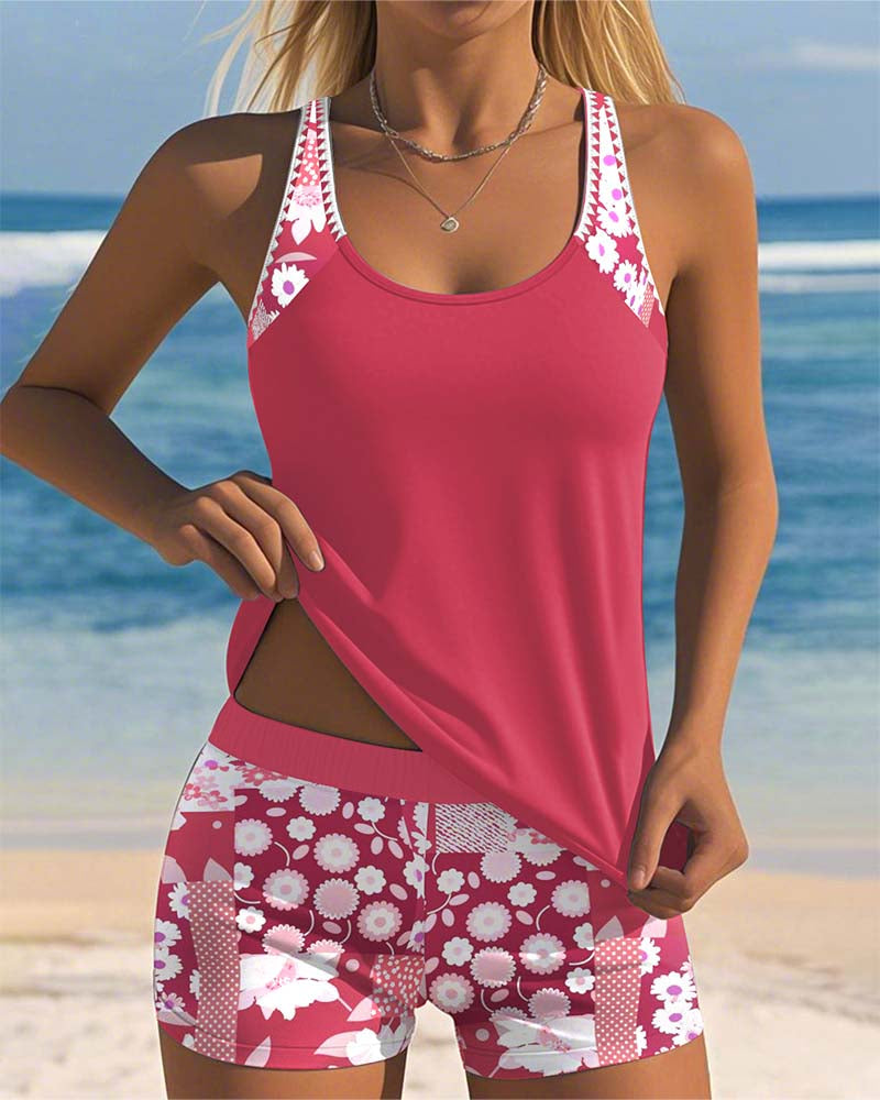 Floral tankini with shorts bottom in purple and soft tones, displayed on a light background