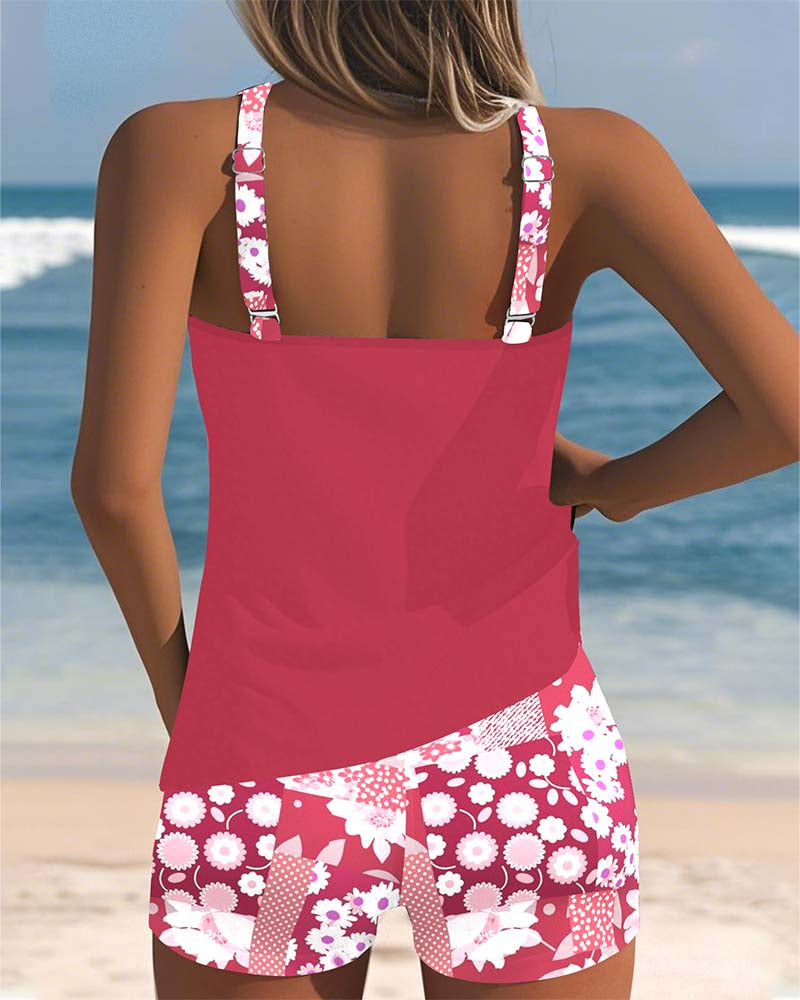 Floral tankini with shorts bottom in purple and soft tones, displayed on a light background