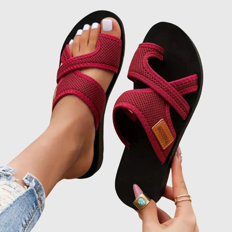 Lightweight flat sandal in black, also available in red and brown, with a simple clean design