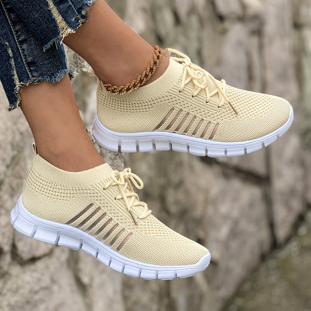 A woman wearing light breathable sock-style comfort shoes
