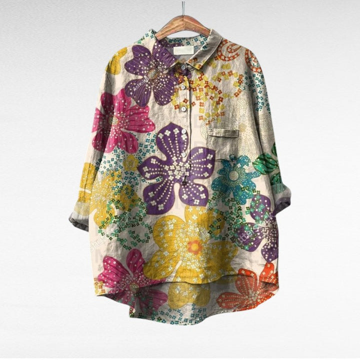 A woman wearing an elegant printed summer blouse with trousers, looking cool and stylish on a warm day.