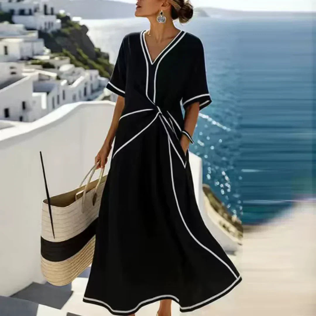 Women's waist-defining dress in blue with a draped front detail and flowy skirt