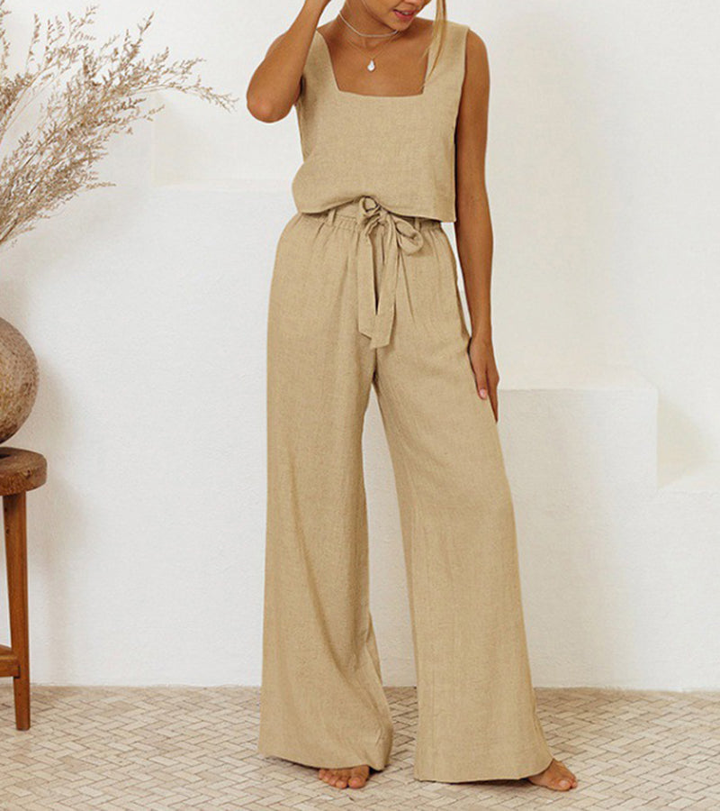 A woman wearing a minimal two-piece set with a square neckline and belted flared trousers.