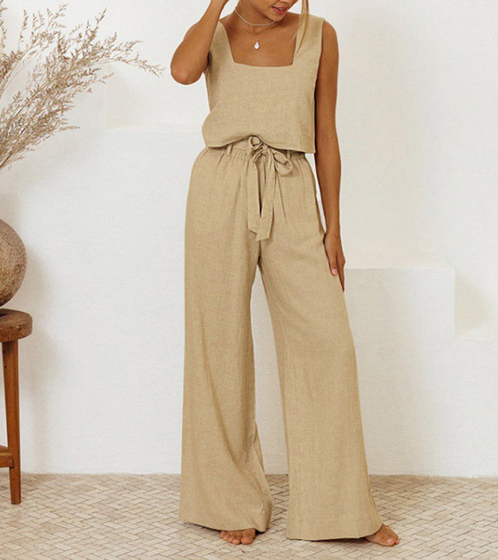 A woman wearing a minimal two-piece set with a square neckline and belted flared trousers.