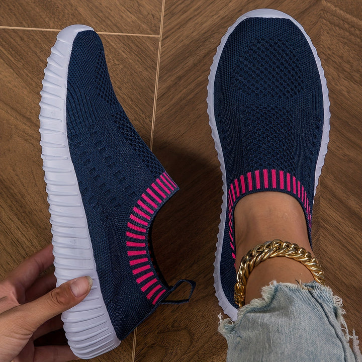 A woman slipping on ultralight sock-style trainers that hug the foot.