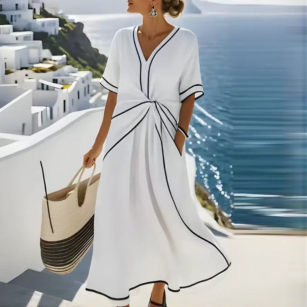 Women's waist-defining dress in blue with a draped front detail and flowy skirt