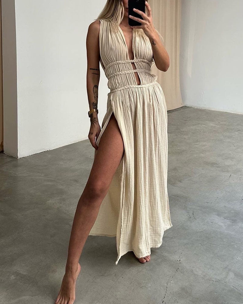 Woman in a softly textured dress with front slit and cinched waist tie at golden hour.