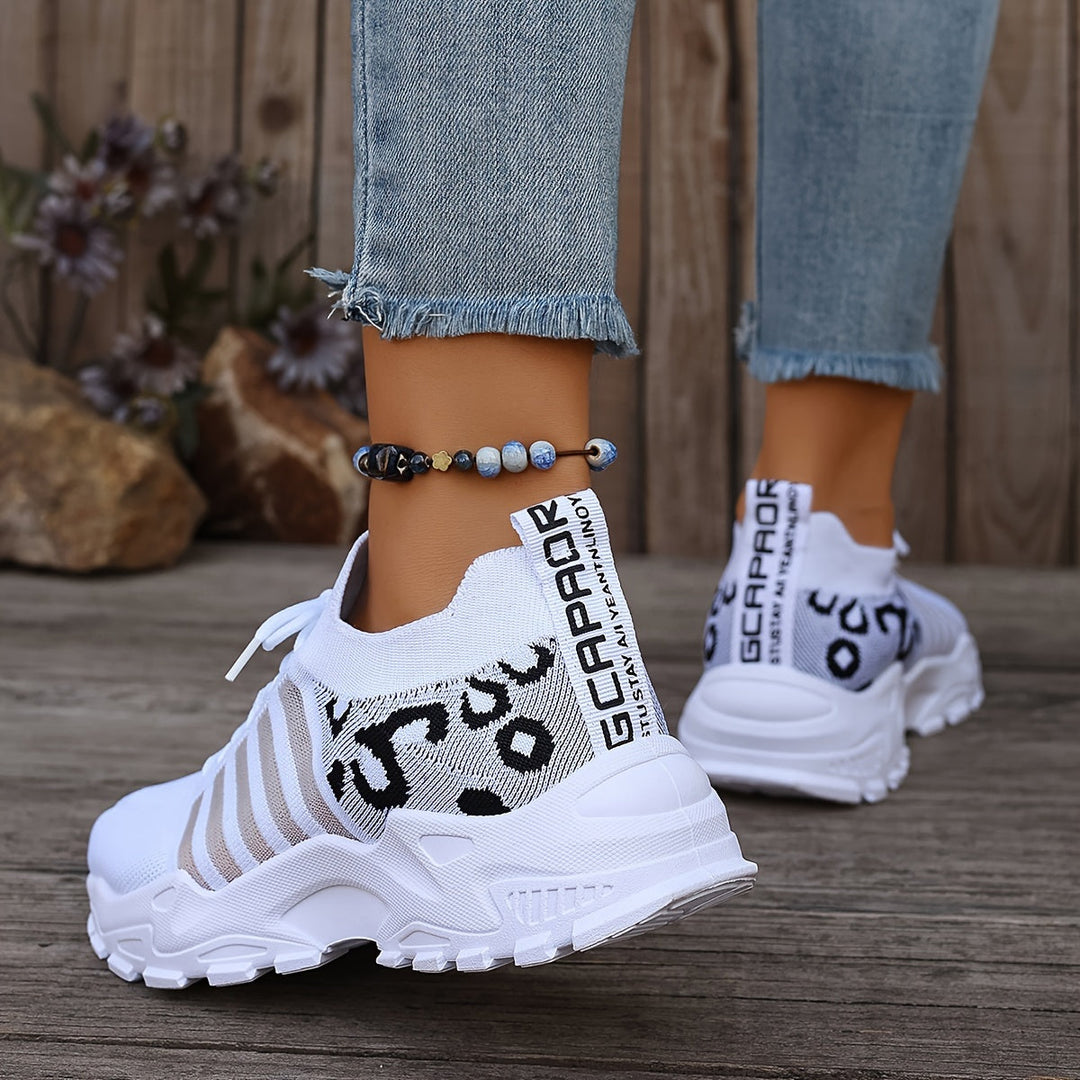 A woman walking in light, breathable comfort trainers on a warm day.