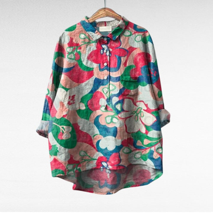 A woman wearing an elegant printed summer blouse with trousers, looking cool and stylish on a warm day.