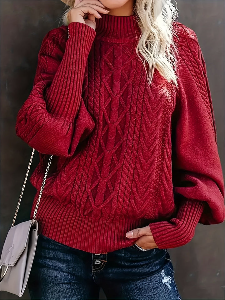 A woman wearing a long, relaxed jumper with long sleeves, soft and cosy for everyday wear.