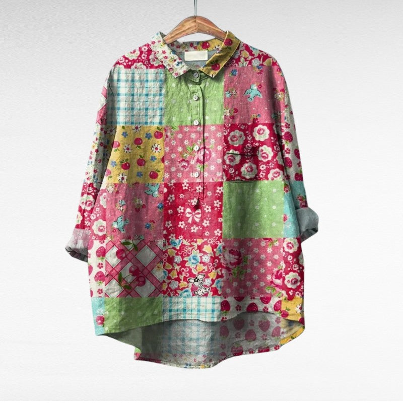 A woman wearing an elegant printed summer blouse with trousers, looking cool and stylish on a warm day.