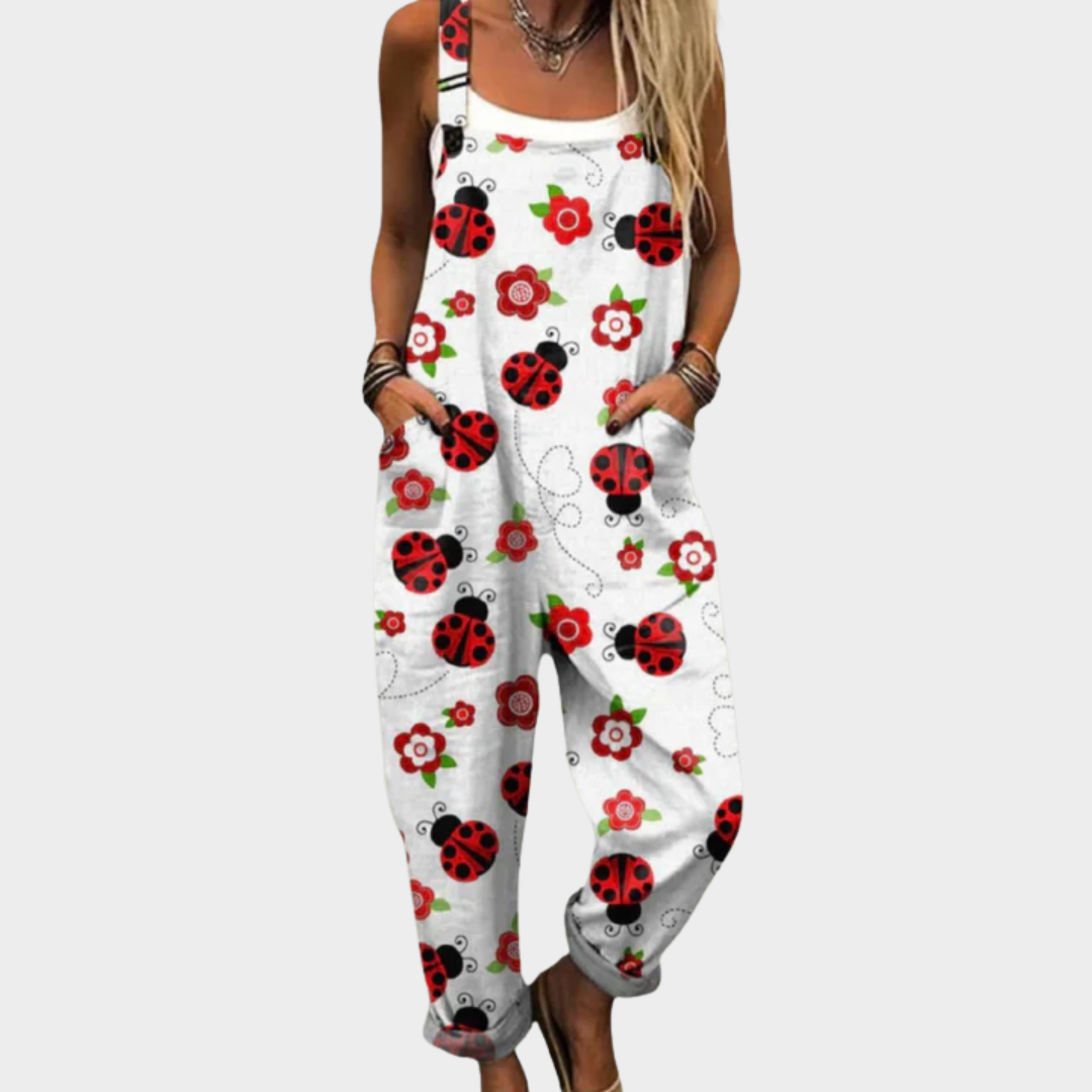 Woman wearing white dungarees printed with cheerful red ladybirds and small red blooms