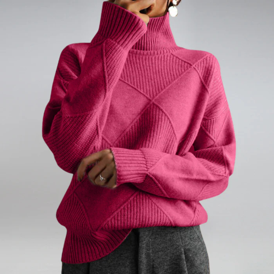 A woman in a stand-collar jumper with an elegant drape, styled with tailored trousers.