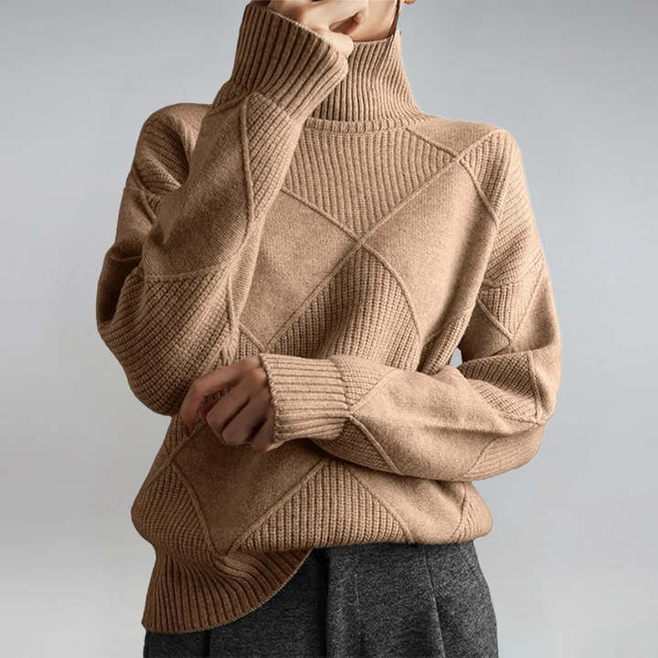 A woman in a stand-collar jumper with an elegant drape, styled with tailored trousers.