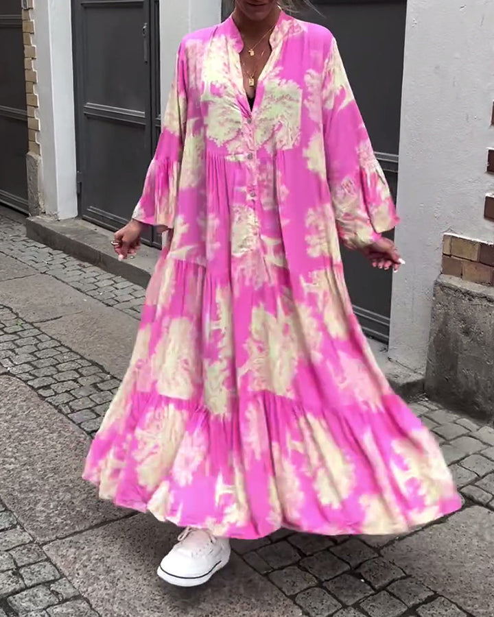Woman wearing the Abigail flowing maxi dress with a delicate print and V-neckline, the skirt moving softly as she walks.