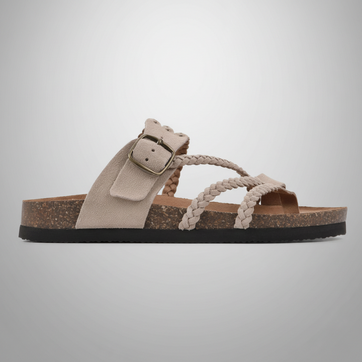 Natural woven flat sandal with an adjustable buckle strap and cushioned footbed