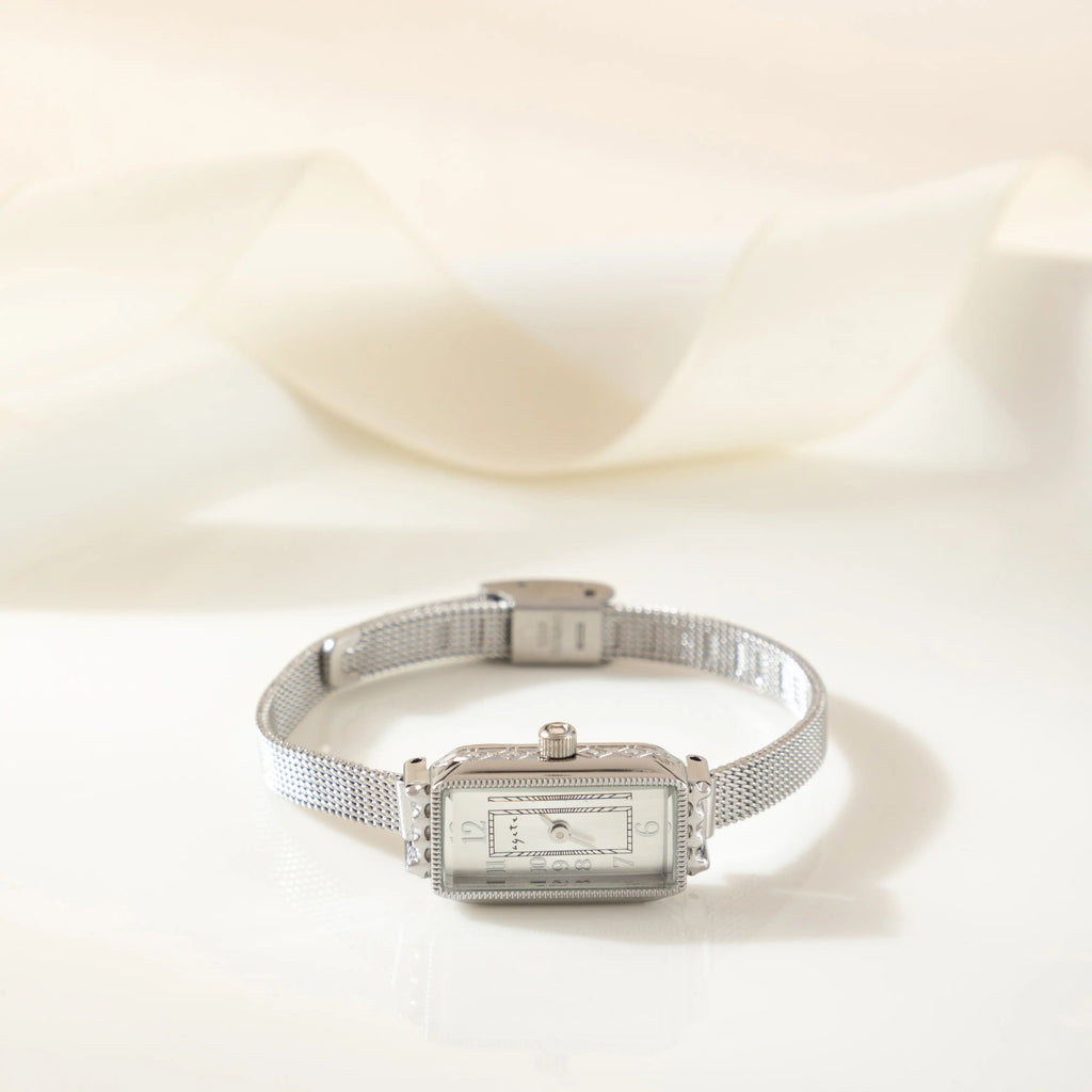 Women's classic watch with a textured strap and rounded dial in warm gold tone