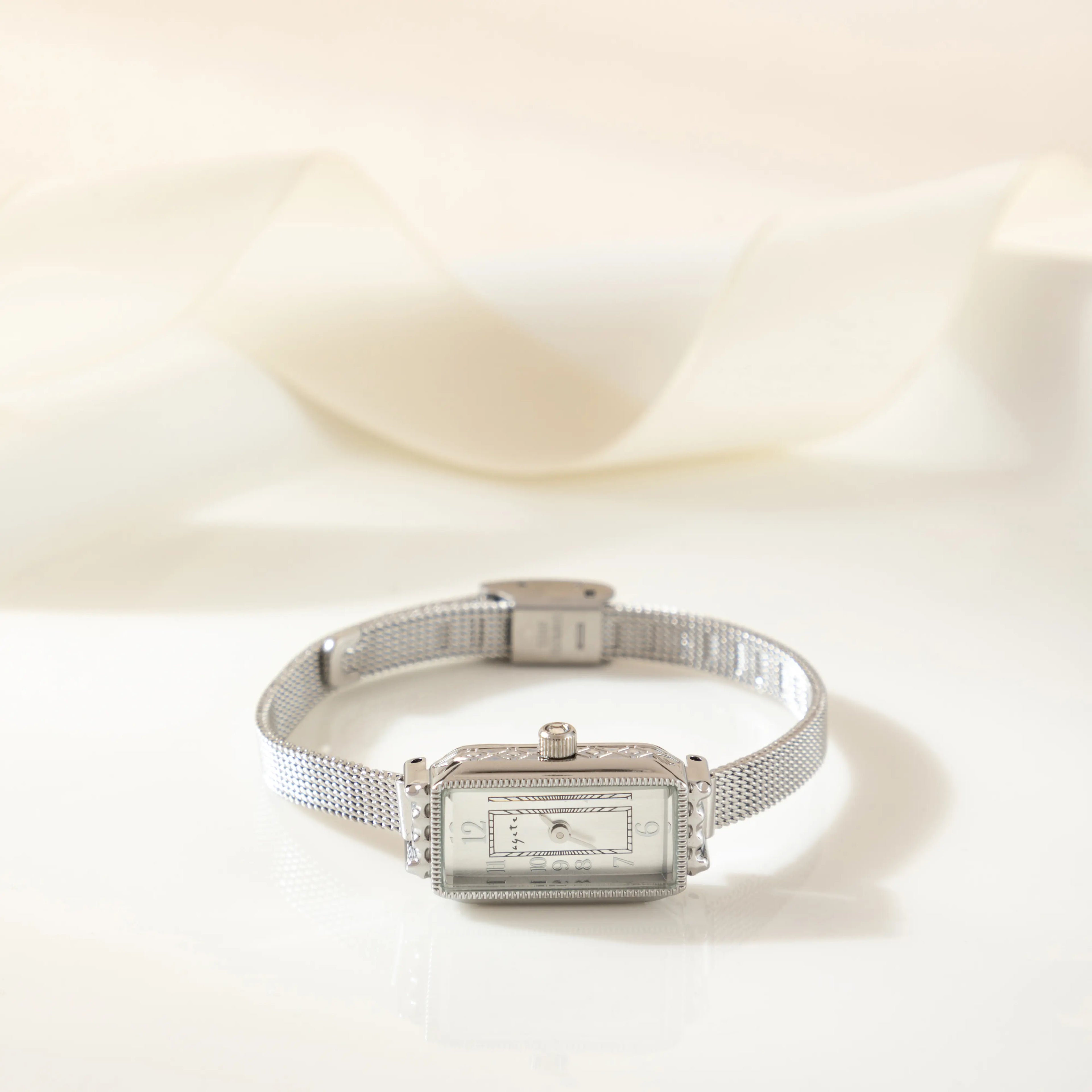 Women's classic watch with a textured strap and rounded dial in warm gold tone