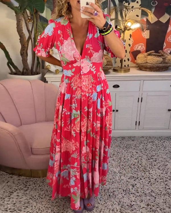 A woman wearing the Josephine bold floral maxi dress with a flowing full-length skirt at a garden gathering.