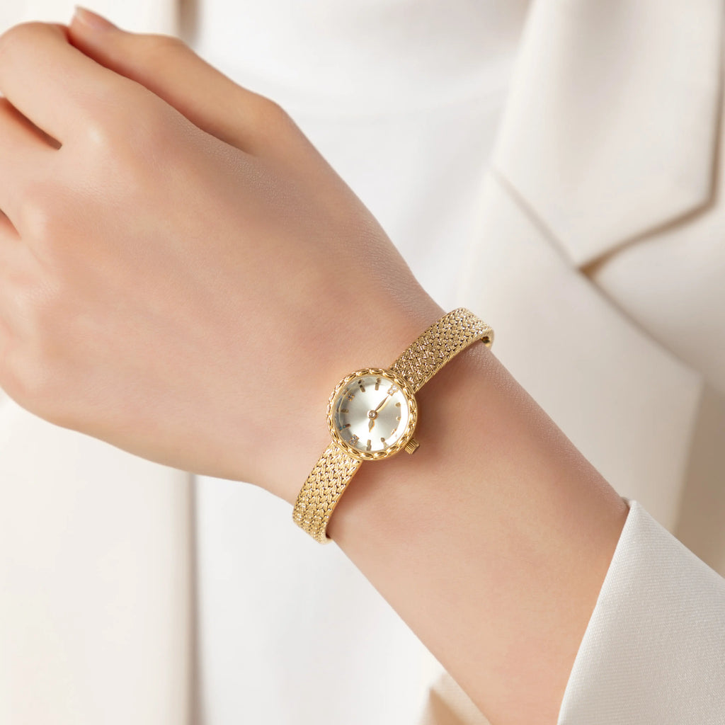 Women's minimalist gold watch with a simple round face and clean gold-tone finish