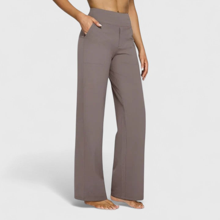 Woman wearing pull-on trousers with a soft blouse, relaxed and comfortable at home.