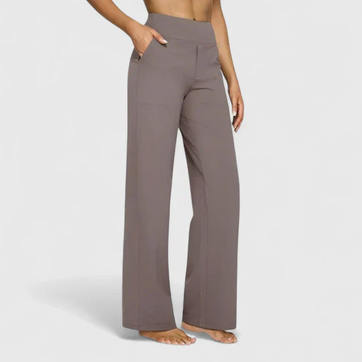 A woman in tailored trousers styled with a simple top for an elegant, comfortable everyday look.