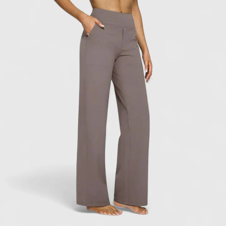 A woman in elegant straight-leg trousers with pockets, styled for a polished everyday look.