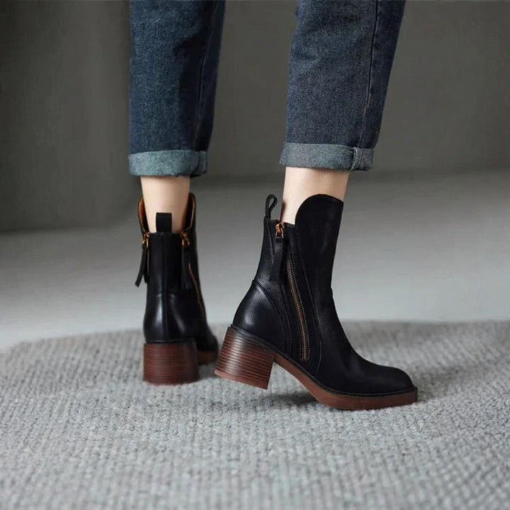 Classic black ankle boots with a stable heel and side zip fastening