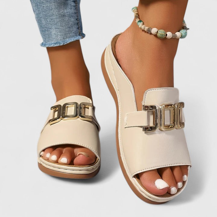A woman walking easily in grey supportive sandals with a cushioned sole and adjustable strap.