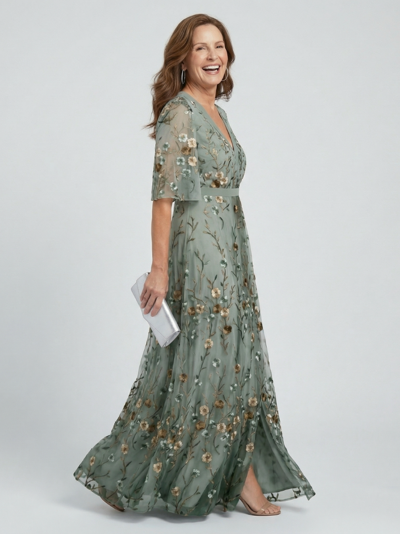 Sage green halter-neck midi dress with all-over floral print and loose flowing silhouette