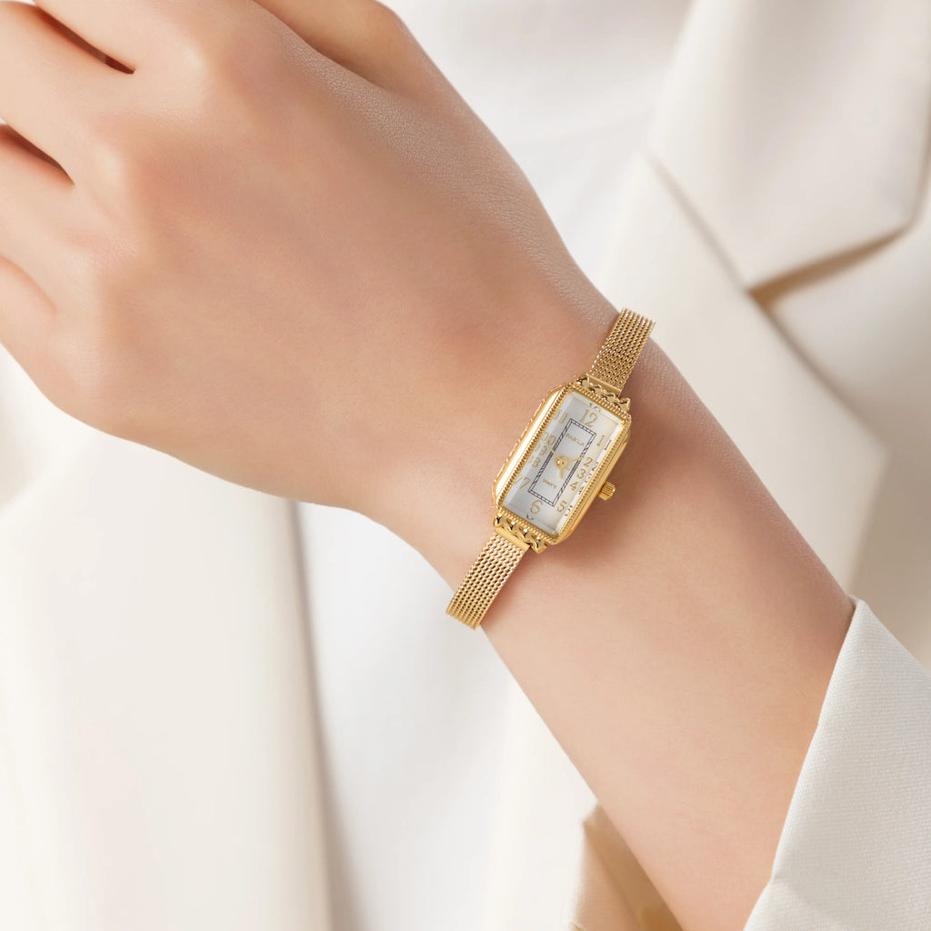Women's classic watch with a textured strap and rounded dial in warm gold tone