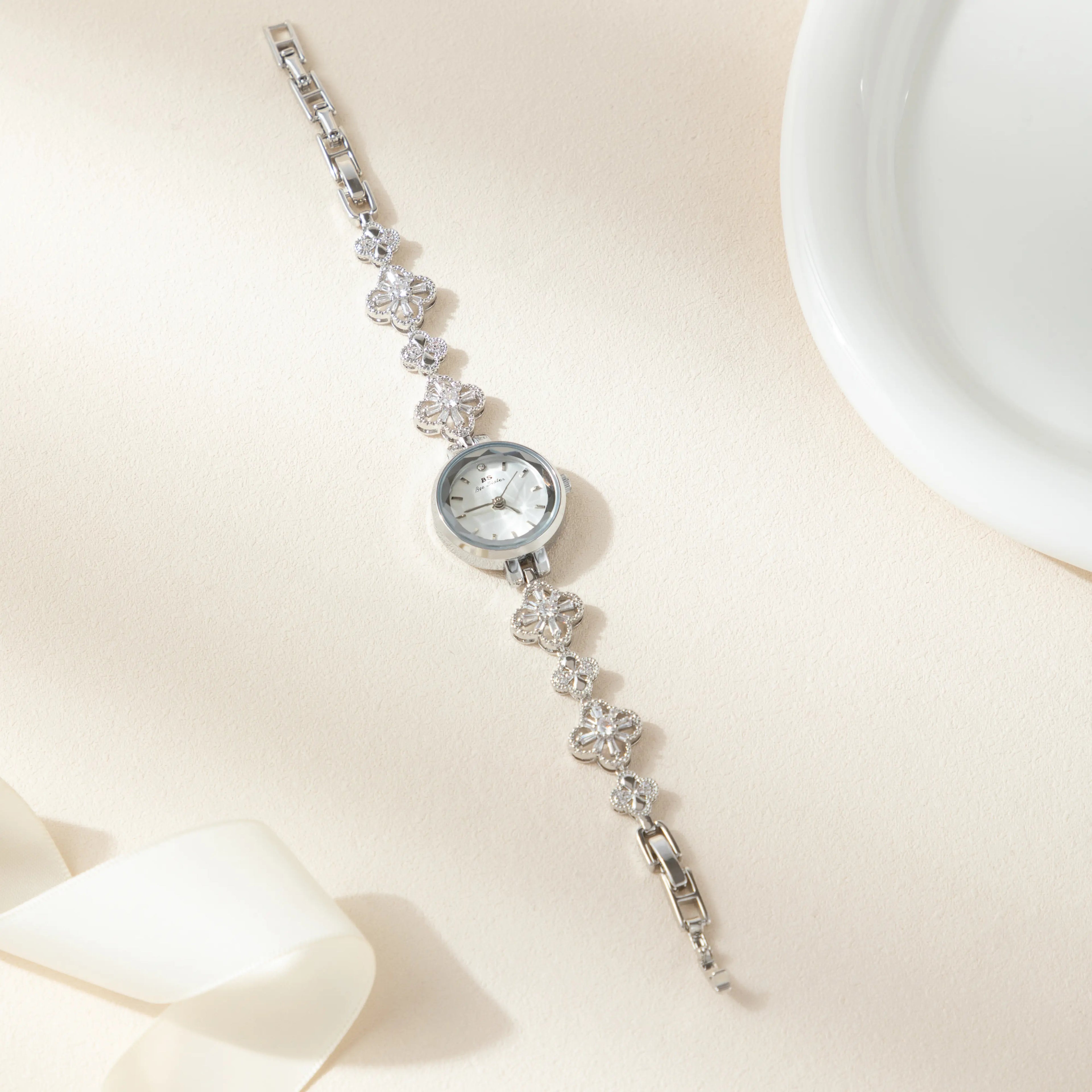 Women's gold-finish watch with rounded design and light-catching detailed face
