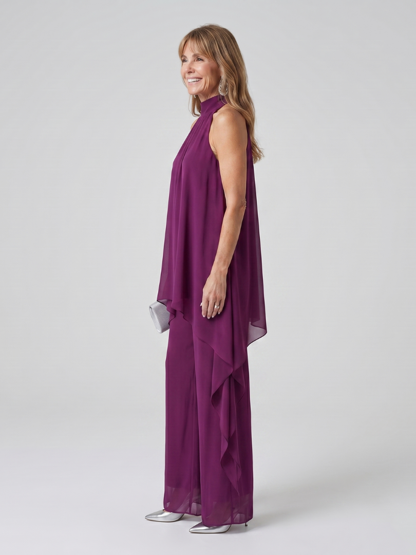 Purple halter neck tunic top with matching wide-leg trousers and a sheer asymmetric overlay