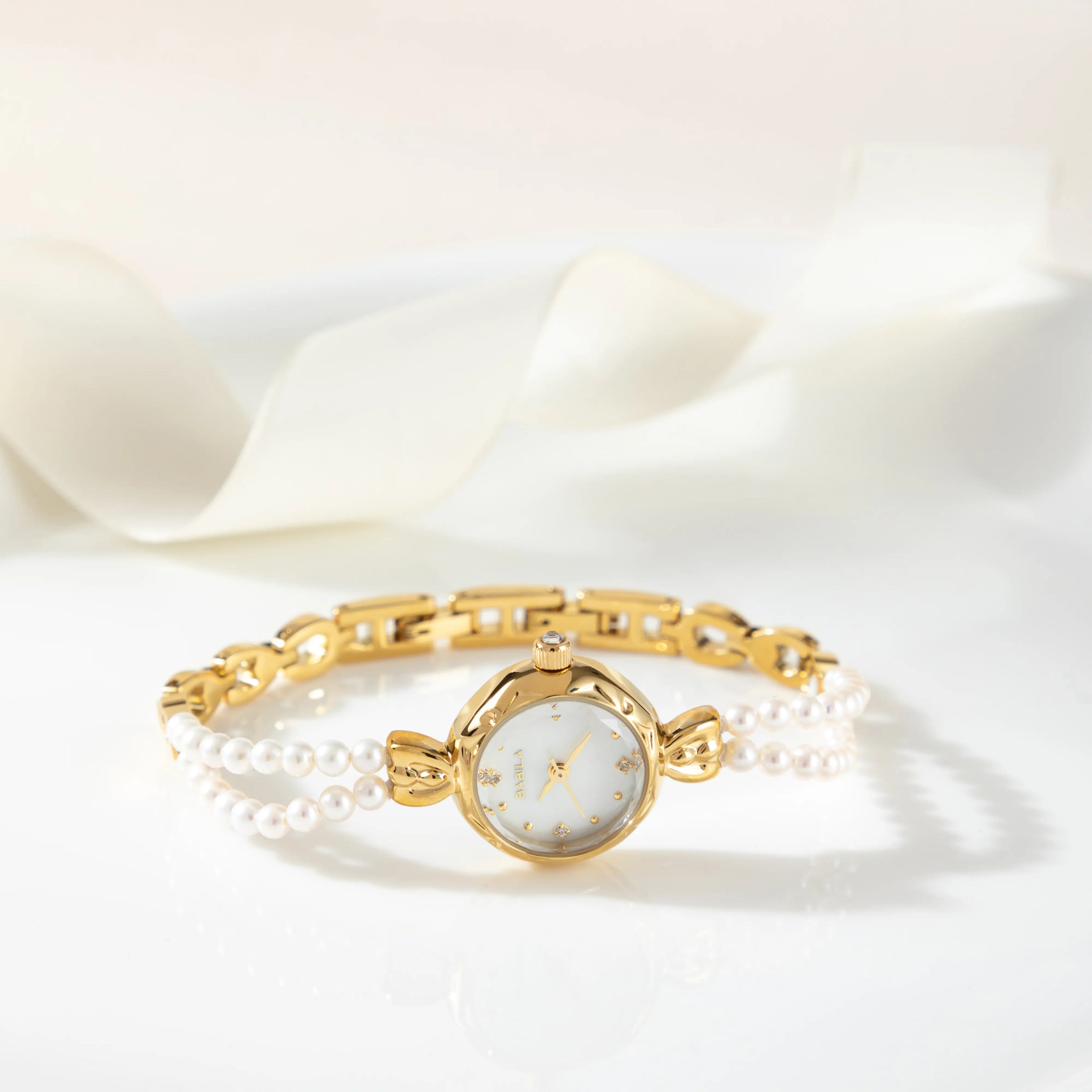 Women's gold watch with elegant twisted chain bracelet strap and a refined dial