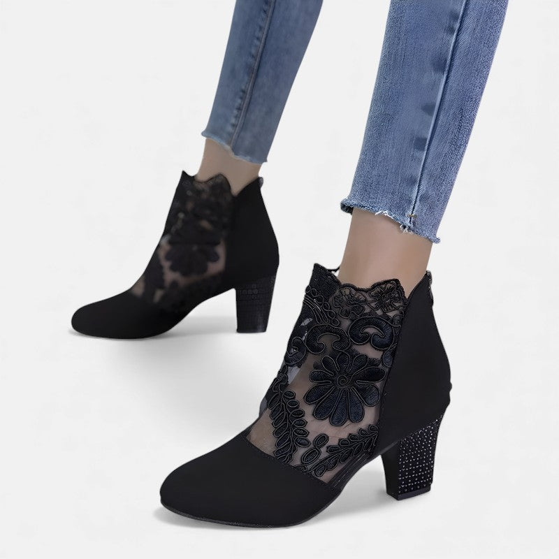 A woman wearing wide-toe orthopaedic heels, standing comfortably in an elegant everyday look.