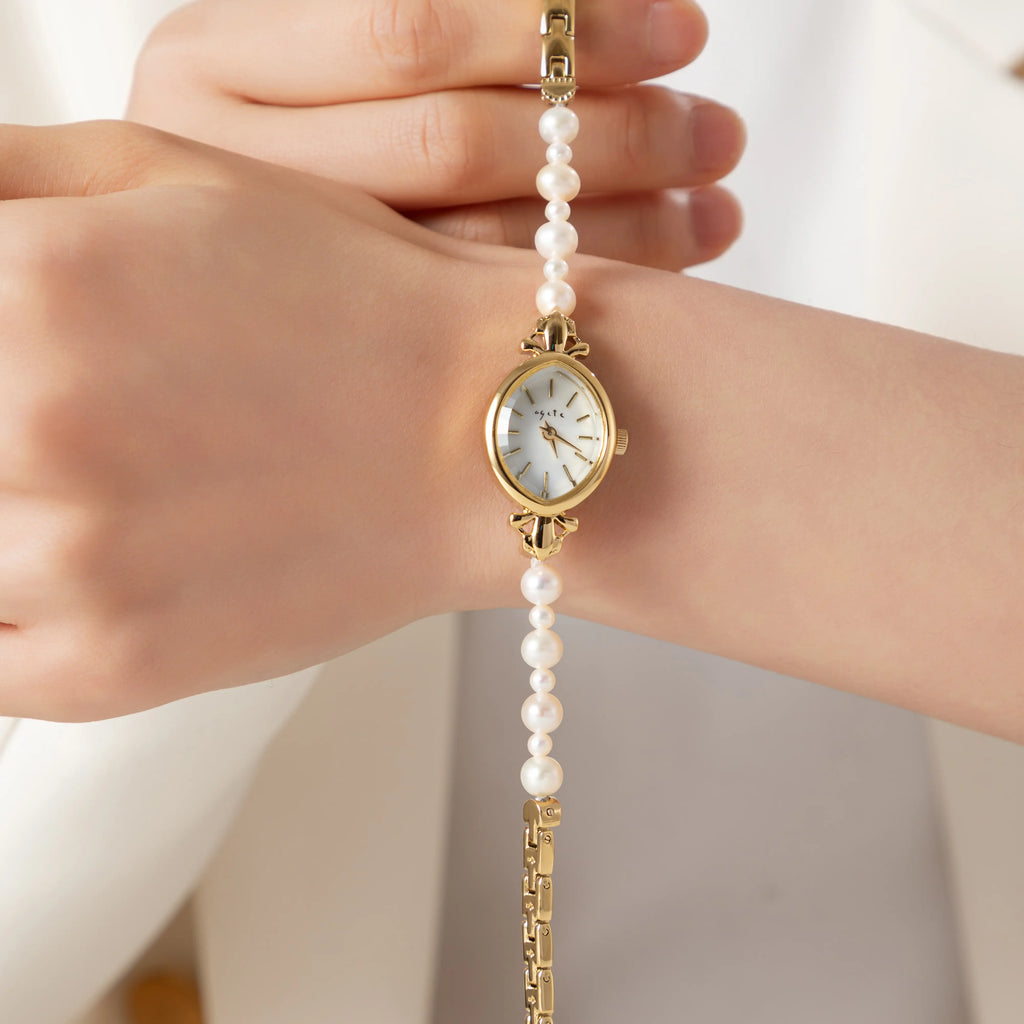 Elegant women's watch with crystal-set dial and delicate golden bracelet strap
