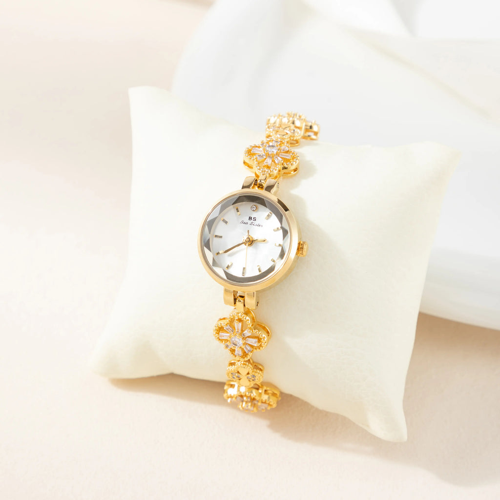 Women's gold-finish watch with rounded design and light-catching detailed face
