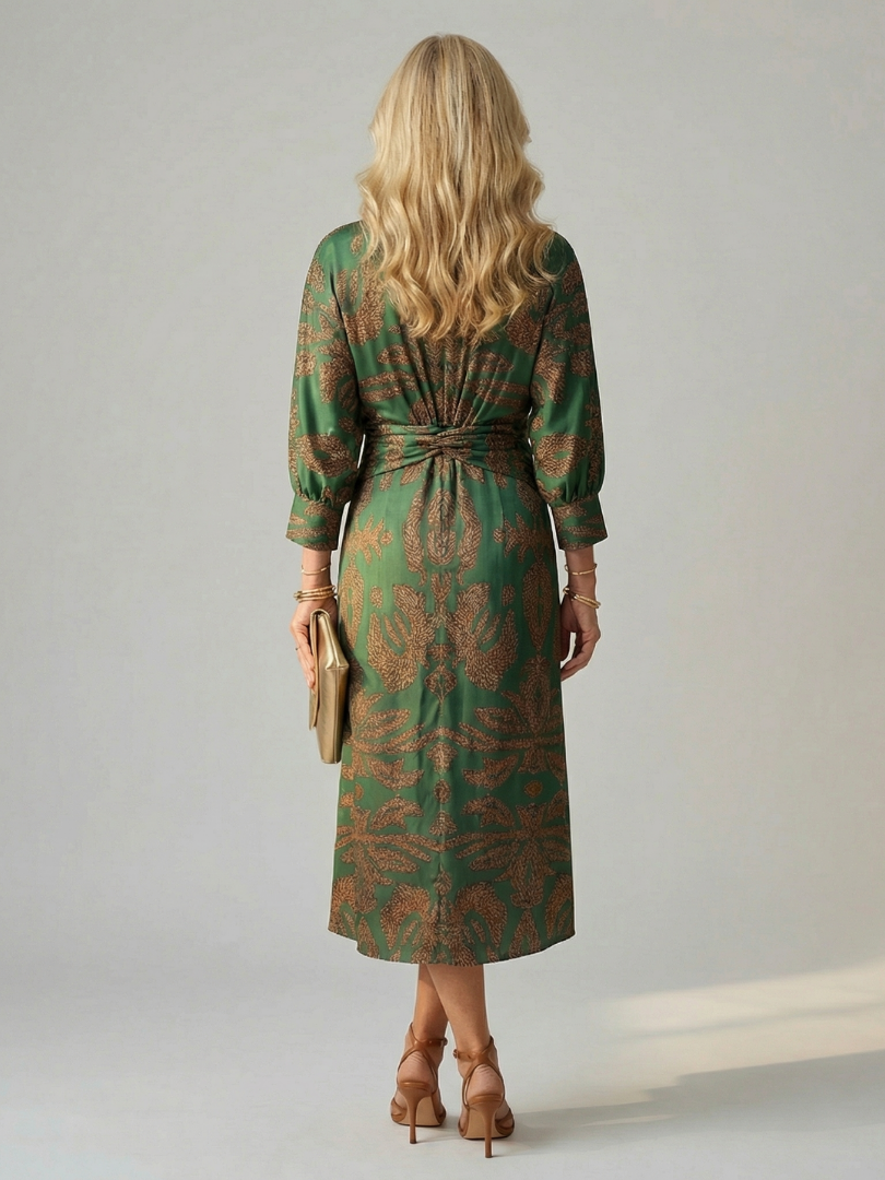 Dark green long-sleeve midi dress with diagonal wrap bodice and straight skirt in a detailed print