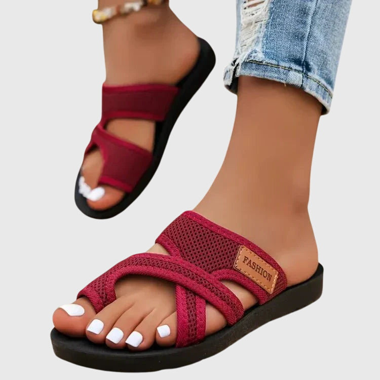 Lightweight flat sandal in black, also available in red and brown, with a simple clean design