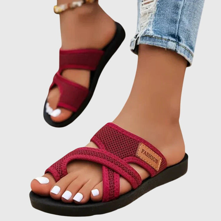 Lightweight flat sandal in black, also available in red and brown, with a simple clean design