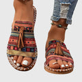Flat boho sandals with colourful printed upper and swinging fringe detail