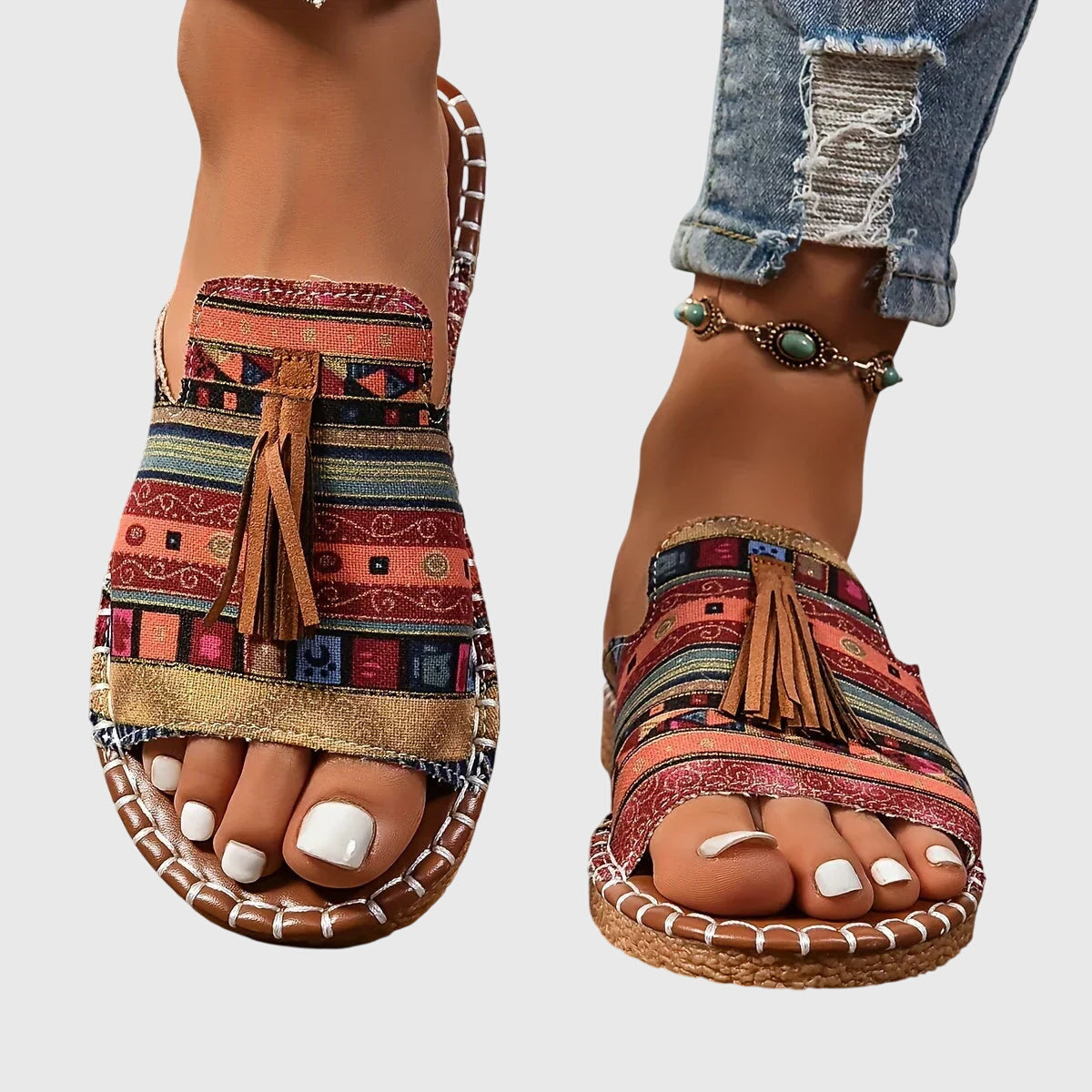 Flat boho sandals with colourful printed upper and swinging fringe detail